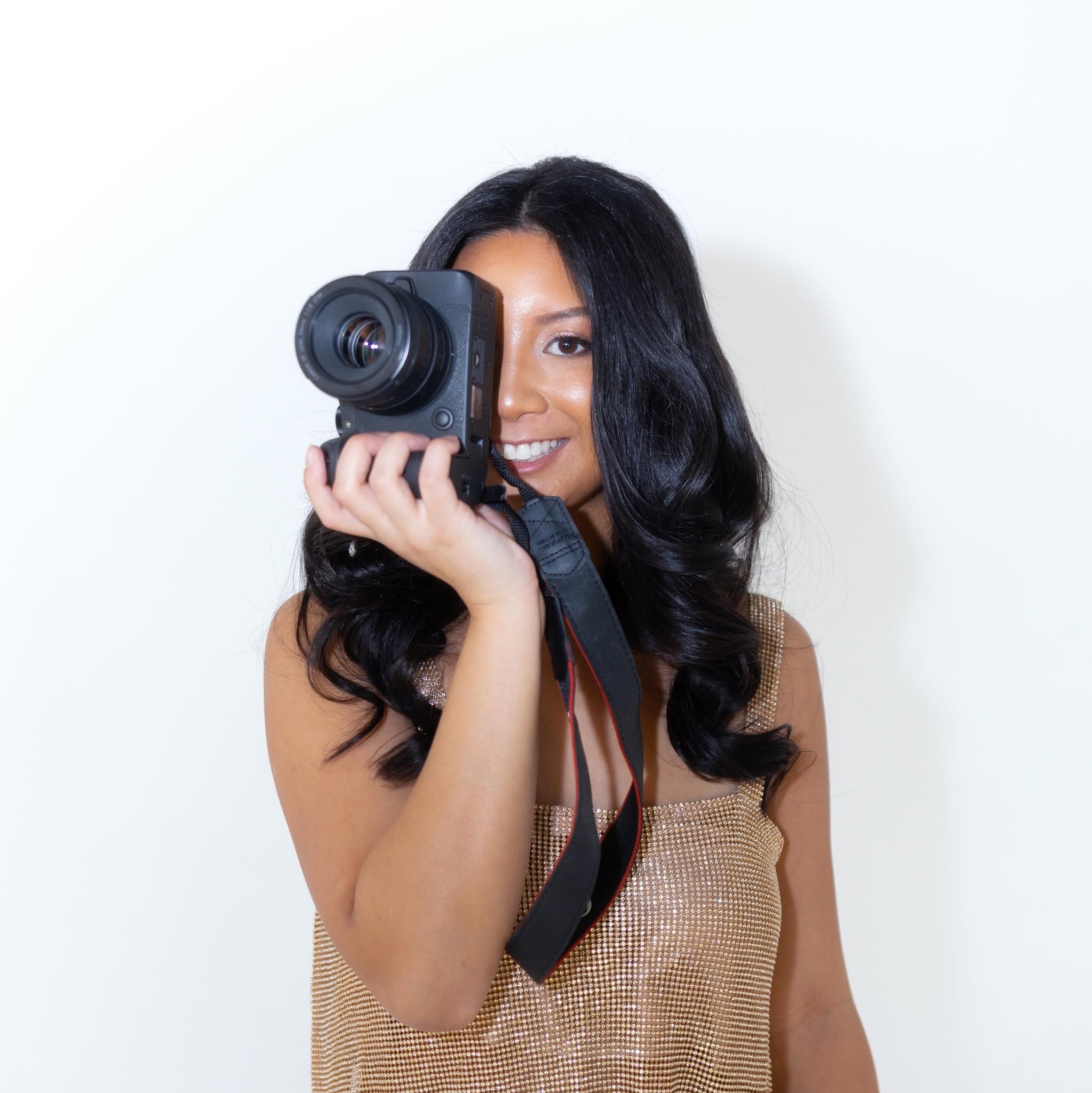 Amber Murray, photographer, smiling with a camera