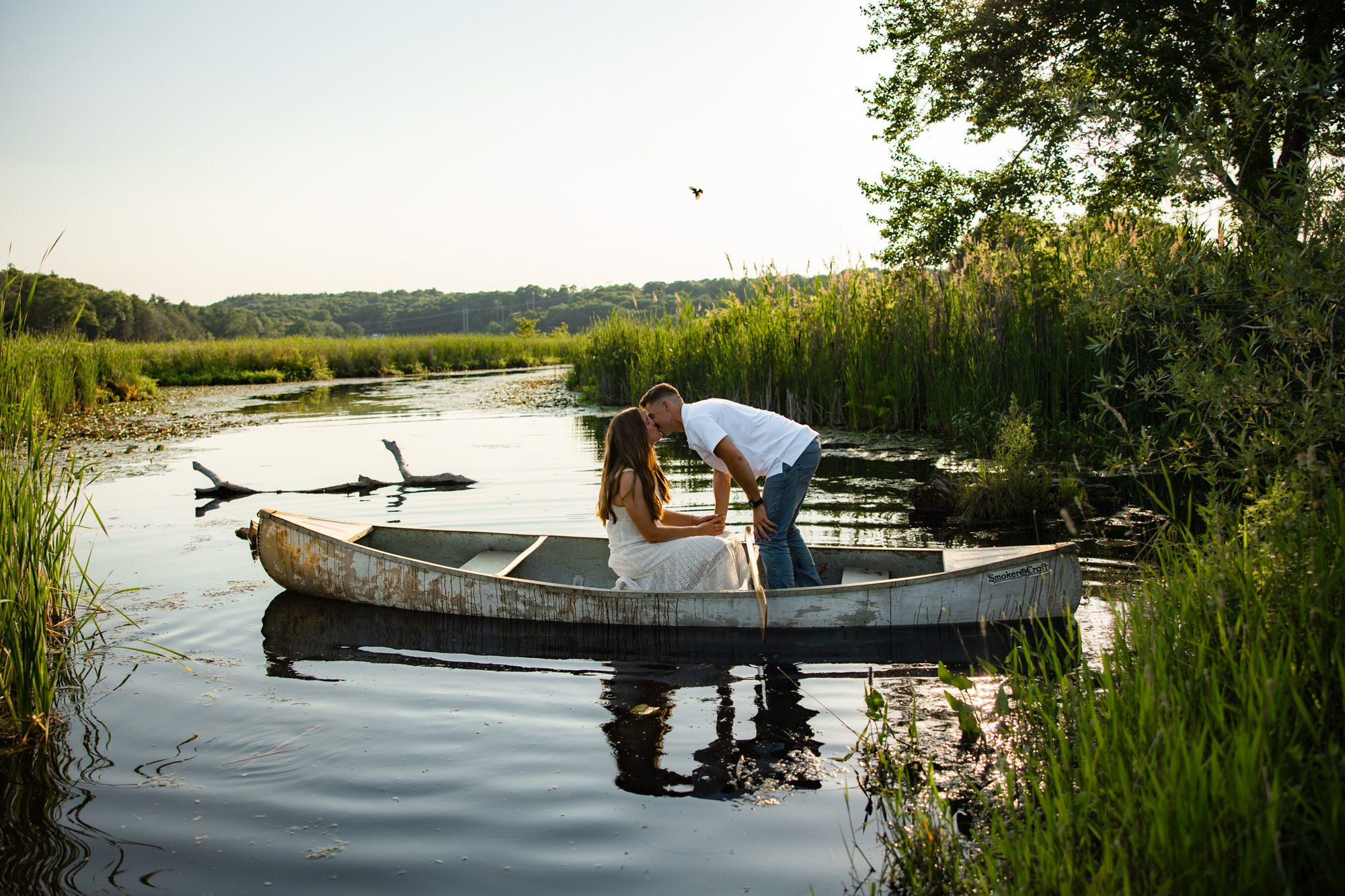 Engaged couple laughing together outdoors